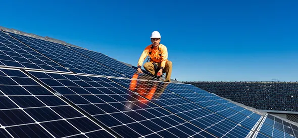Professional solar panel installer setting up solar system in Portland, ME